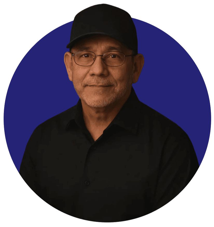 Founder John Aguirre – Faith & Freedom Woodworks Portrait of John Aguirre, founder of Faith & Freedom Woodworks, wearing a black shirt and cap, smiling against a dark blue circular background.